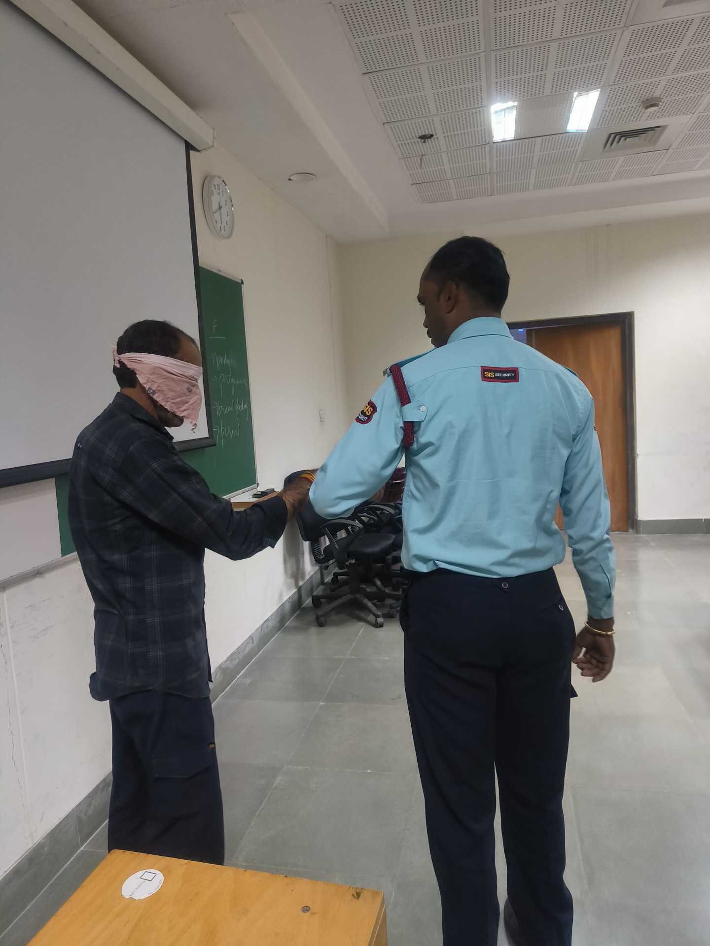 Blindfold activity by two security guards